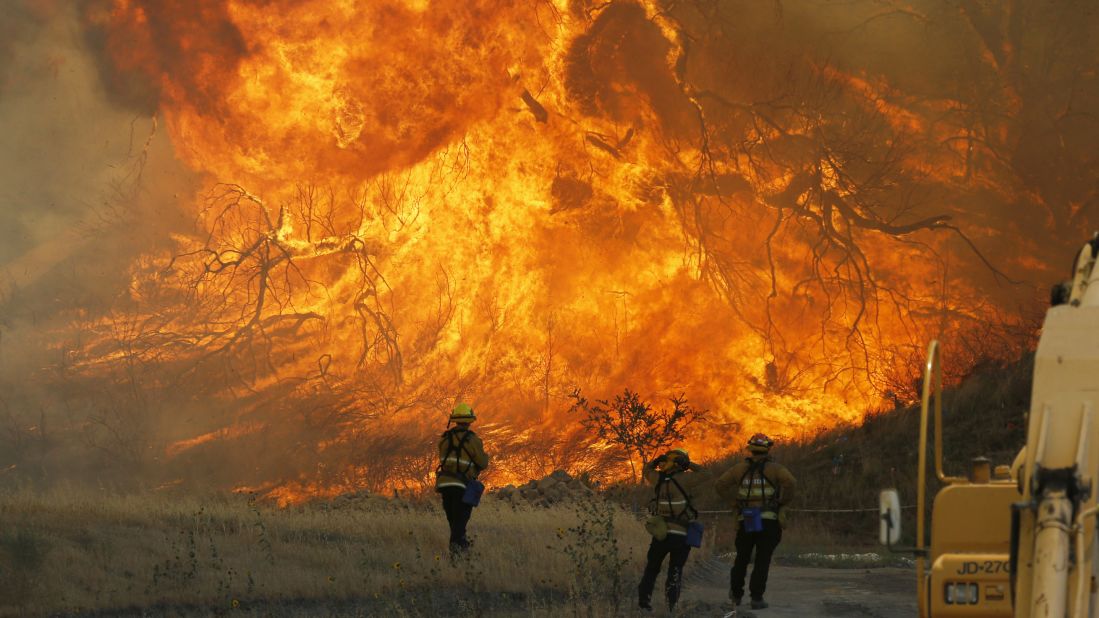 A hillside erupts in flame in Placerita Canyon in Santa Clarita, California on Monday, July 25. Fire officials said the so-called Sand Fire was growing at the rate of 10,000 acres per day and could potentially spread in any of three directions depending on changing winds. The wildfire has already scorched more than 33,000 acres and destroyed at least 18 homes. 