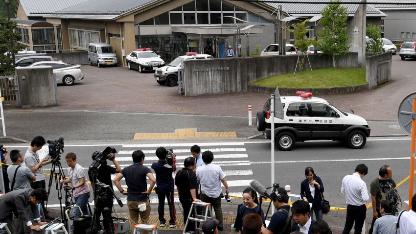 Journalists gather at the main gate of the Tsukui Yamayuri En care center where a knife-wielding man went on a rampage in the city of Sagamihara, Kanagawa prefecture, some 50 kms (30 miles) west of Tokyo on Tuesday, July 26. At least 19 people were killed when the man went on a rampage at the care centre for the mentally disabled in Japan early on Tuesday, a fire official said.