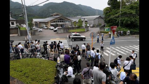 Journalists gather at the main gate of the Tsukui Yamayuri-en care center