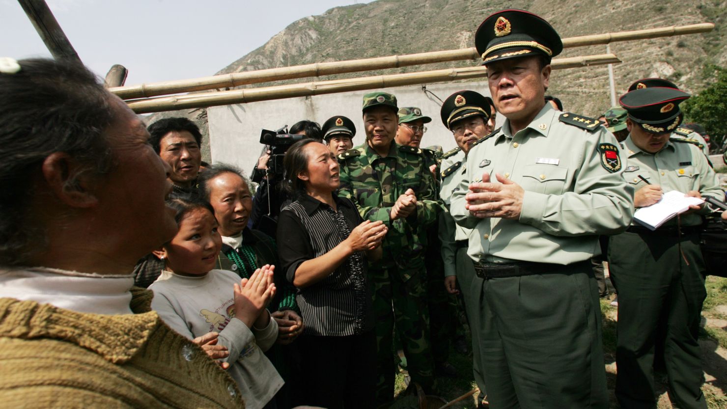 Former top Chinese general Guo Boxiong (right) has been sentenced to life in prison for accepting bribes.