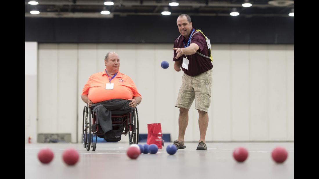 U.S. Army veterans Tom Brown, left, and Tom Southall learn to play bocce Sunday, July 10, during the National Veterans Golden Age Games in Detroit.