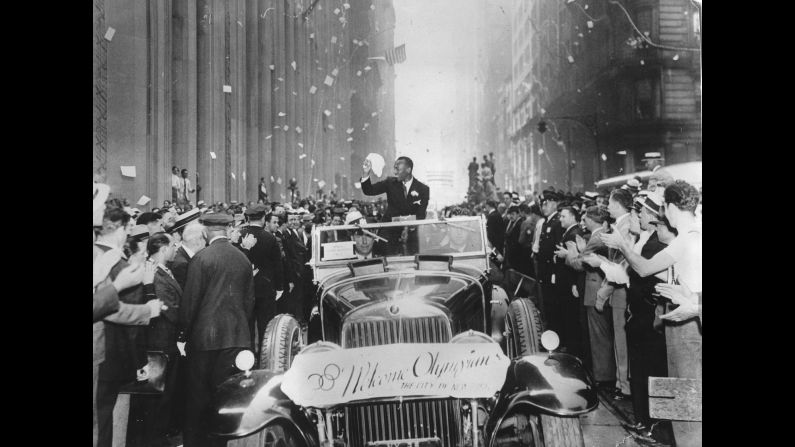 Owens takes part in a ticker-tape parade in New York in September 1936.