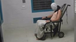 The "Four Corners" program reported that this image shows Dylan Voller, then 17, in a white hood, shackled at the neck with his arms strapped to a chair at a detention center in Alice Springs, Australia.