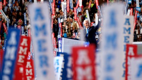 Former U.S. President Bill Clinton waves to the crowd before giving a speech on Tuesday.
