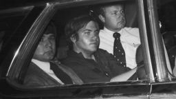 In this file photo from April 1981, John Hinckley, Jr. is driven away from U.S. District Court. Hinckley was seated in the center seat of a nine-seat section station with agents assigned to protect him, seated in front, alongside, and behind him. 