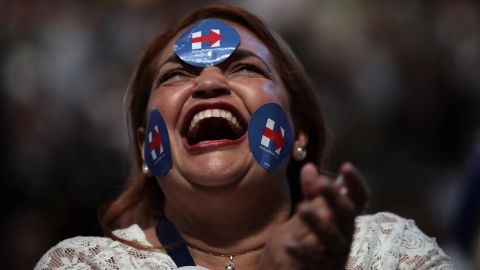 A delegate wears stickers in support of Clinton.