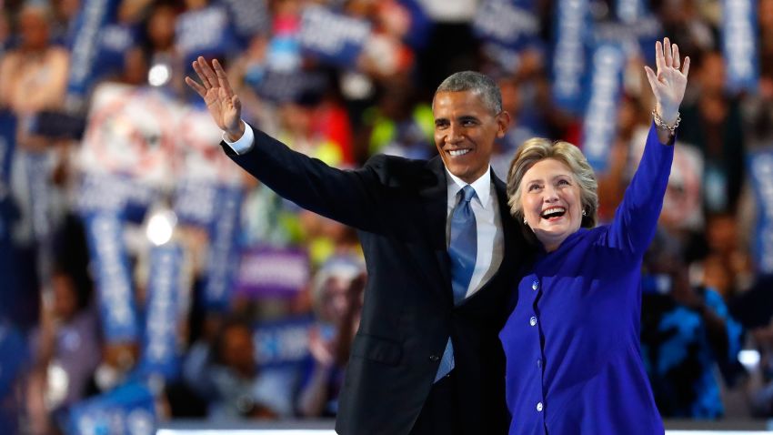 US President Barack Obama and Democratic presidential candidate Hillary Clinton wave to the crowd on the third day of the Democratic National Convention at the Wells Fargo Center, July 27, 2016 in Philadelphia, Pennsylvania. Democratic presidential candidate Hillary Clinton received the number of votes needed to secure the party's nomination. An estimated 50,000 people are expected in Philadelphia, including hundreds of protesters and members of the media. The four-day Democratic National Convention kicked off July 25.