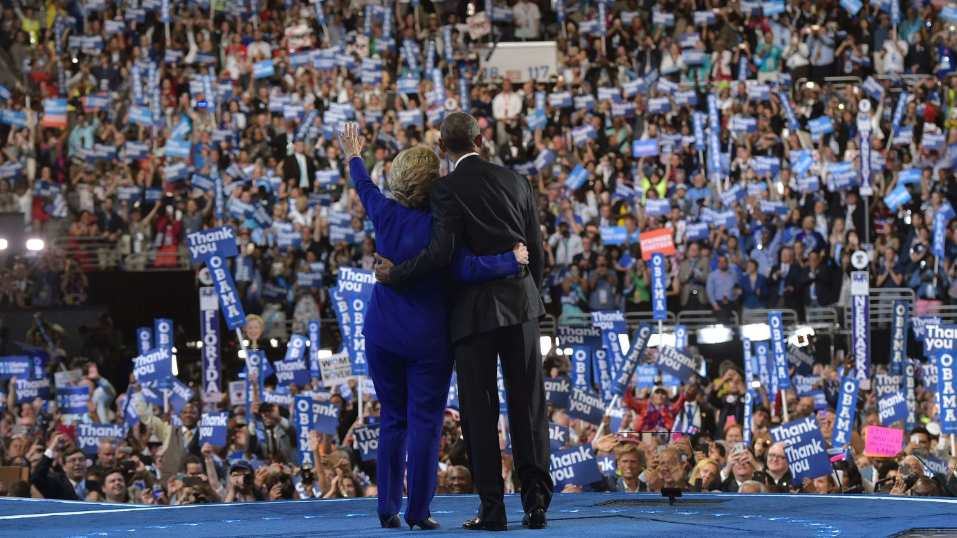 Obama and Clinton acknowledge the crowd.