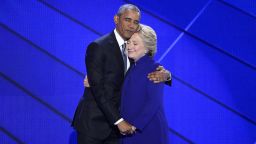 U.S. President Barack Obama hugs Hillary Clinton, 2016 Democratic presidential nominee, on stage during the Democratic National Convention (DNC) in Philadelphia, Pennsylvania, U.S., on Wednesday, July 27, 2016. With the historic nomination for the first woman to run as the presidential candidate of a major U.S. political party, Democrats gathered in Philadelphia hoped they had turned a corner on Tuesday.
