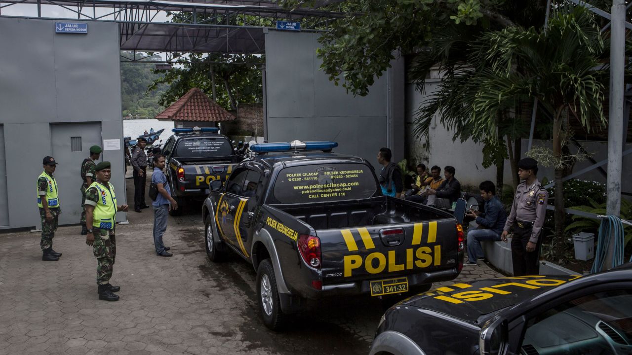 Police patrol cars arrive to an Indonesia prison.