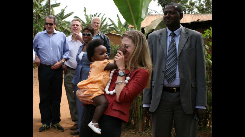 A baby pinches Chelsea's nose as she and her father visit a rural health-care clinic in Rwanda in August 2008. The former President was visiting Clinton Foundation projects in four African countries.