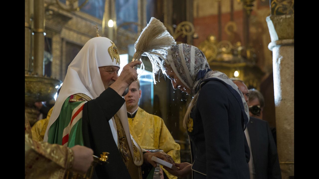 Russian Orthodox Church Patriarch Krill, left, blesses one of the athletes.