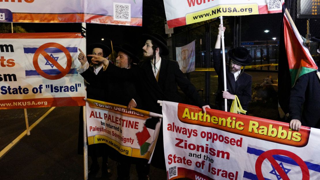 Less than 100 feet from protests that saw seven people arrested by the Secret Service for breaching a security fence late Wednesday, a group of anti-Israel Orthodox Jews held a mostly quiet demonstration. Some carried Palestinian flags while other handed out pamphlets to curious passersby. The name of the group, "Neturei Karta," translates from Aramaic to "Guardians of the City."