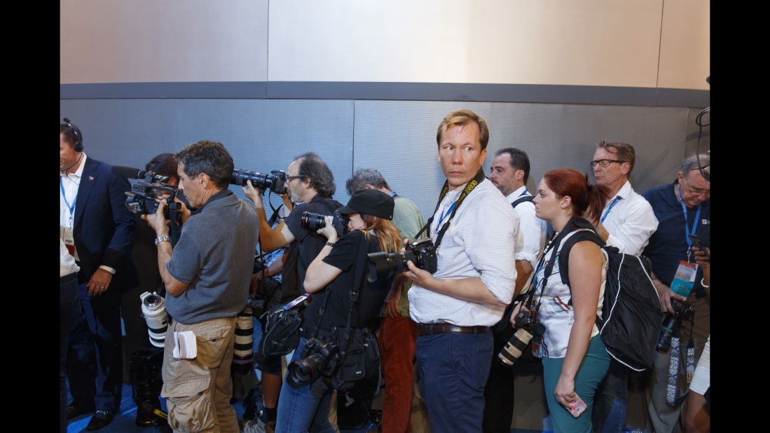 Photographers work inside the arena.