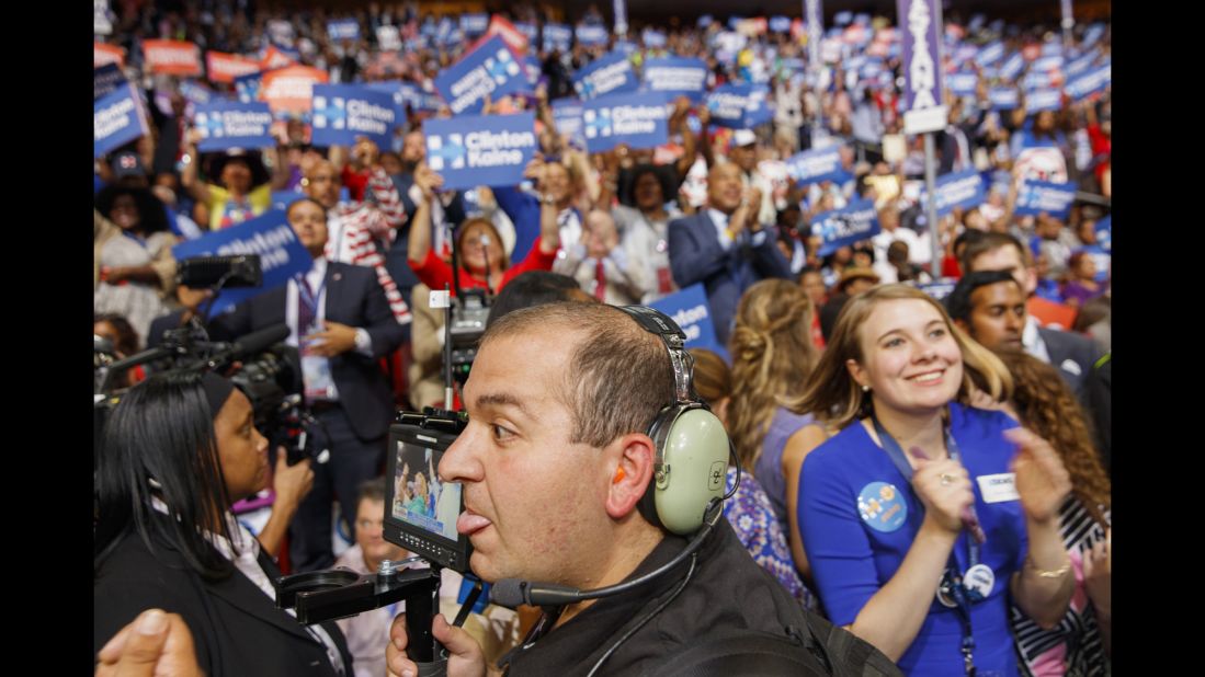 Media members film Hillary Clinton supporters on the convention floor.