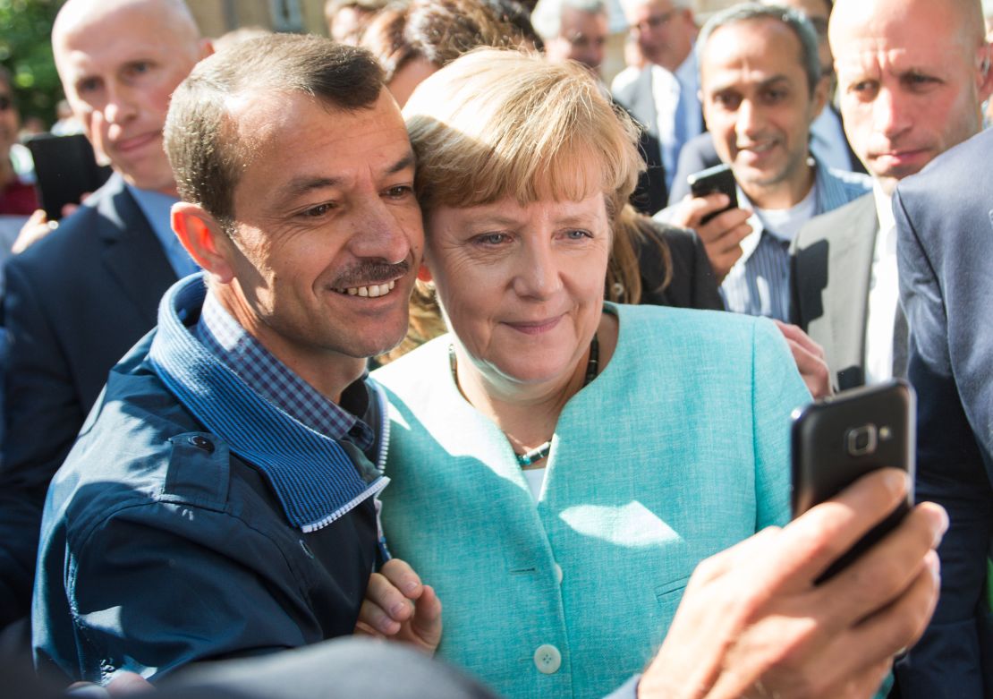 An asylum-seeker takes a selfie with Chancellor Angela Merkel during the leader's visit to a refugee registration in Berlin, in September 2015.