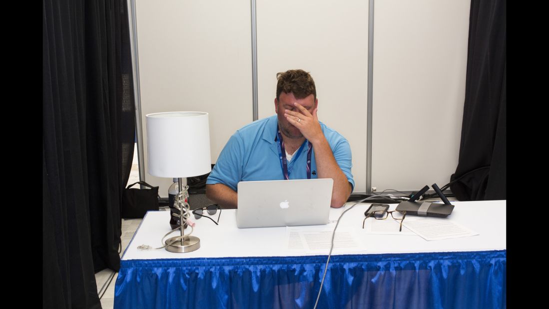 A man works in one of the media tents.