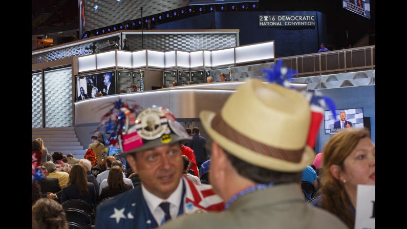 Media members work above the convention floor during a speech.