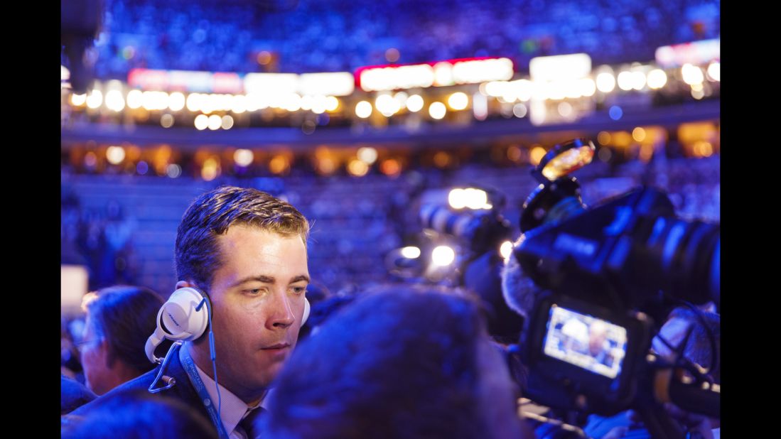 A broadcast journalist works inside the arena.