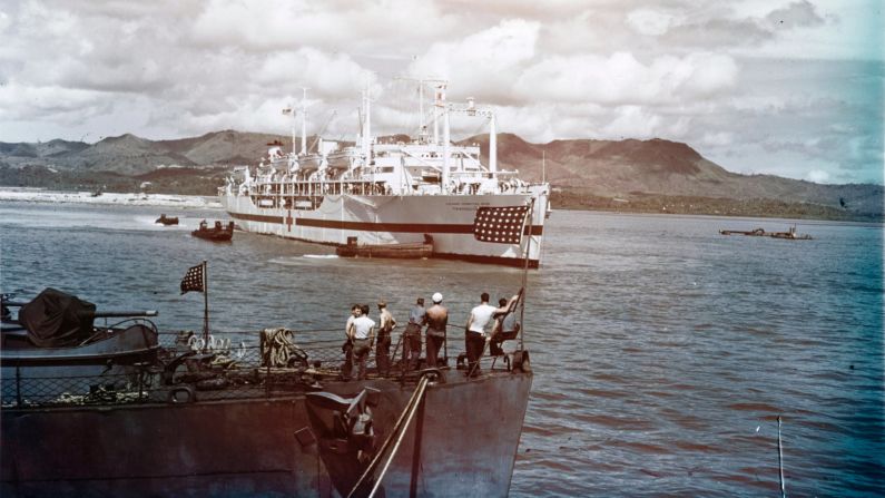 The USS Tranquillity arrives at Guam, carrying survivors of the USS Indianapolis sinking. Hundreds of men had been in the water for days, battling dehydration, exhaustion, exposure and sharks. A Navy plane spotted them by chance a few days after the sinking.