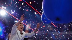 US Democratic Presidential Candidate Hillary Clinton reaches for ballooons on the final day of the 2016 Democratic National Convention on July 28, 2016, at the Wells Fargo Center in Philadelphia, Pennsylvania.