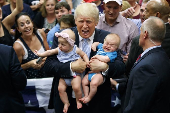 Republican presidential nominee Donald Trump holds Kellen Campbell of Denver, right, and Evelyn Keane, of Castle Rock, Colorado, during a campaign rally on Friday, July 29 in Colorado Springs.