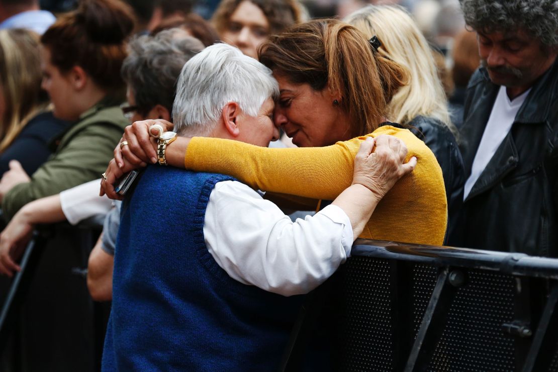At a memorial ceremony for Rev. Jacques Hamel, woman hugs Sister Daniele Delafosse, a nun who taken hostage during the attack.