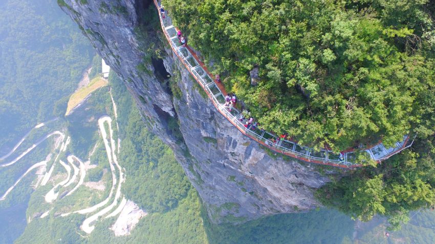 Aerial view of the 100-meter-long and 1.6-meter-wide glass skywalk overlooking the "Tianmen Tongtian Avenue" on the cliff of Tianmen Mountain (or Tianmenshan Mountain) in Zhangjiajie National Forest Park in Zhangjiajie city, central China's Hunan province, 1 August 2016.

A 100-meter-long and 1.6-meter-wide glass skywalk in Zhangjiajie Tianmenshan National Park opened to visitors on Monday (1 August 2016). The Coiling Dragon Cliff skywalk is the third glass skywalk on the Tianmen Mountain (or Tianmenshan Mountain) in Zhangjiajie National Forest Park in central China's Henan province. It oversees the "Tianmen Tongtian Avenue" (Avenue toward Heaven), featuring a total of 99 road turns, layers after another, known as "the first highway wonders".
