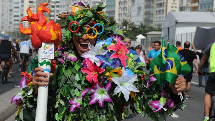 A man disguised as Batman holds a fake Olympic torch reading "Shame" during a protest against suspended president Dilma Rousseff and former president Luiz Inacio Lula Da Silva, at Copacabana beach in Rio de Janeiro, Brazil, on July 31, 2016.
Protesters took to the streets of Brazil on Sunday to demand the final leaving of suspended President Dilma Rousseff or to defend her continuance, just five days before the start of the Rio 2016 Olympic Games. / AFP / TASSO MARCELO        (Photo credit should read TASSO MARCELO/AFP/Getty Images)