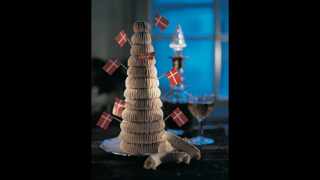 Kransekage in Danish (or kransekake in Norwegian) is composed of differently sized ring cakes, made with ground almonds, arranged in a stack. 