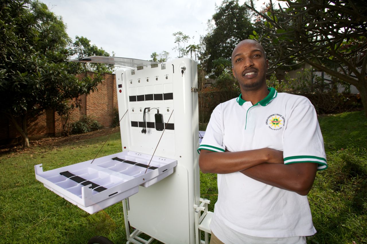Solar energy innovator Henri Nyakarundi with his portable mobile charging kiosk in Rwanda.