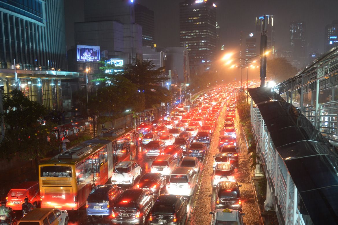 Motorists trespass in the bus lane, forcing a bus into traffic during the city's peak rush hour in Jakarta, on November 13, 2015.  