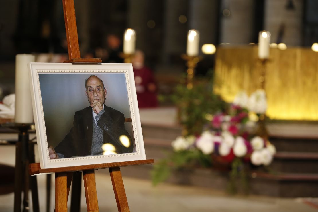 A picture of the slain priest appears at his funeral. His killing in a house of worship has rocked France.