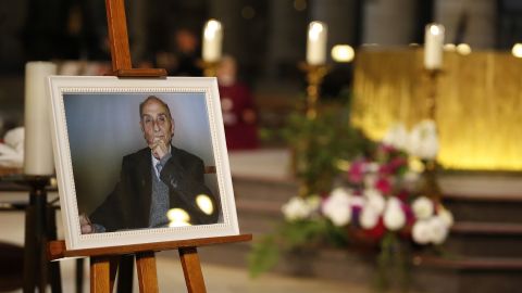 A picture of the slain priest appears at his funeral. His killing in a house of worship has rocked France.