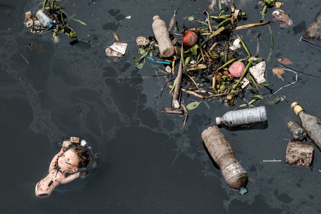 View of floating debris carried by the tide and caught by the "eco-barrier" before entering Guanabara Bay.