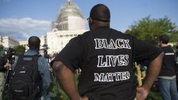 A man wears a "Black Lives Matter" t-shirt as he demonstrates along with the group Justice League NYC and others participate in a March2Justice rally for criminal justice reform legislation to end racial profiling and demilitarize police forces outside the US Capitol in Washington, DC, April 21, 2015. Some members of the group spent a week traveling from New York City to Washington, ending with a protest rally on the National Mall. AFP PHOTO / SAUL LOEB        (Photo credit should read SAUL LOEB/AFP/Getty Images)
