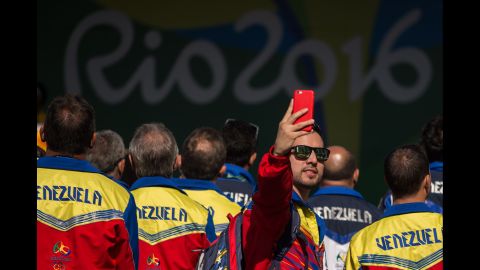 A member of Venezuela's Olympic team takes a selfie during a welcoming ceremony at the Olympic Village on August 2.