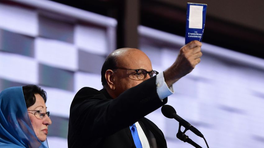 Khizr Khan (R), accompanied by his wife Ghazala Khan (L), holds up a copy of the US Constitution as he speaks about their son US Army Captain Humayun Khan who was killed by a suicide bomber in Iraq 12 years ago, on the final night of the Democratic National Convention at the Wells Fargo Center, July 28, 2016 in Philadelphia, Pennsylvania. 