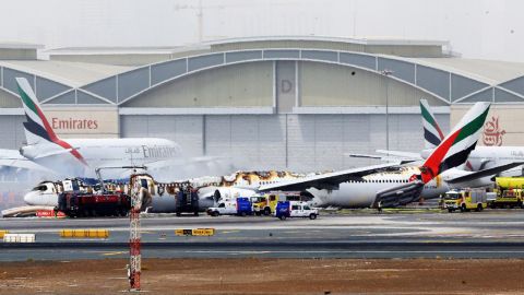The burnt plane sits on a tarmac with part of the fuselage missing.