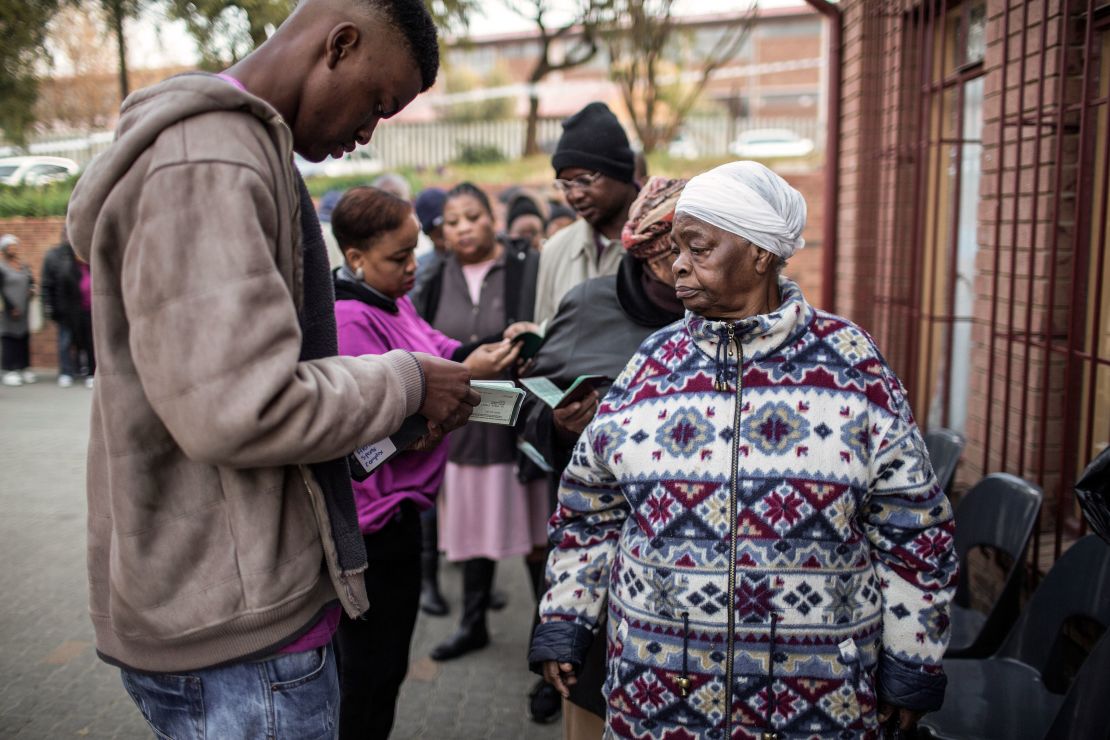 South African voters show their IDs before voting Wednesday in municipal elections in Johannesburg.
