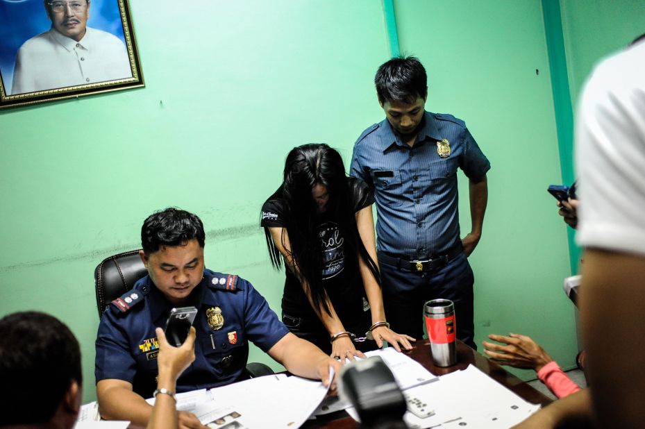 A suspected female member of a drug syndicate is presented by police in Manila on June 22, 2016.