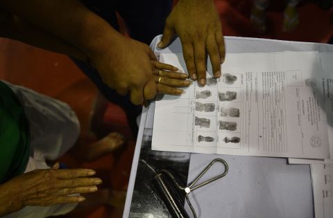 A man authorities accused of being a drug user is fingerprinted during the mass surrender of some 1,000 alleged drug users and pushers in the Philippine town of Tanauan, located about 37 miles (60 kilometers) south of Manila on July 18, 2016.