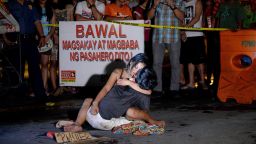 EDITORS NOTE: Graphic content / A woman hugs her husband, next to a placard which reads "I'm a pusher", who was shot dead by an unidentified gunman in Manila on July 23, 2016.
Philippine President Rodrigo Duterte swept to power in May on a promise to clampdown on drugs, and police have since confirmed killing nearly 200 people in a two-month crime blitz. There has also been a surge in killings by anti-drug vigilantes who leave victims' corpses on city streets wrapped in packaging tape with signs accusing them of being drug dealers.
 / AFP / NOEL CELIS        (Photo credit should read NOEL CELIS/AFP/Getty Images)