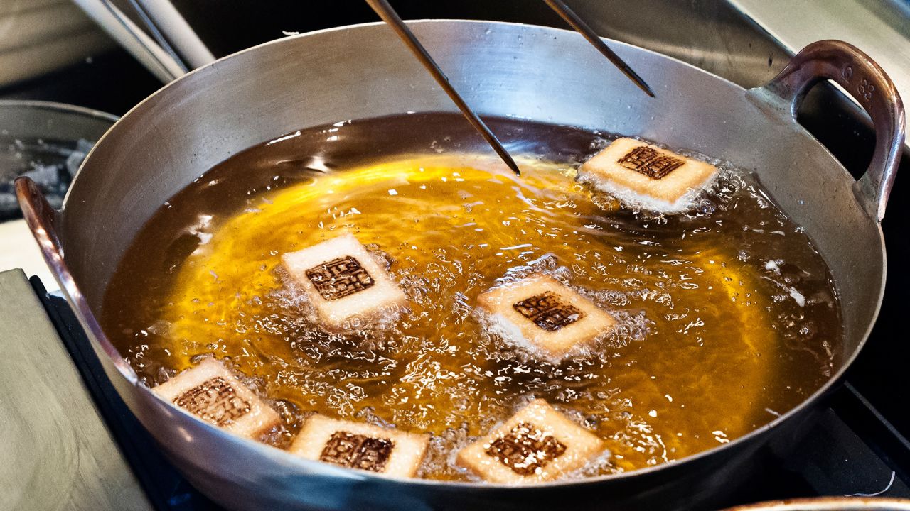 At Tempuro Endo, diners can admire delicacies like shrimp toast turning golden.