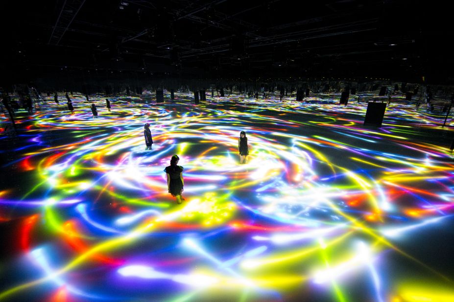 In "Drawing on the Water Surface Created by the Dance of Koi and People - Infinity," visitors walked through knee-deep water while digital fish swam around. 