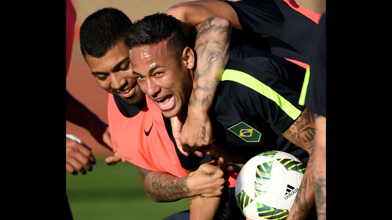 Brazilian soccer players Neymar, right, and Gabriel Jesus joke during a training session in Brasilia, Brazil, on August 1.