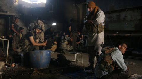 Opposition fighters rest in Aleppo's Ramouseh area as they try to end the Syrian government's seige.