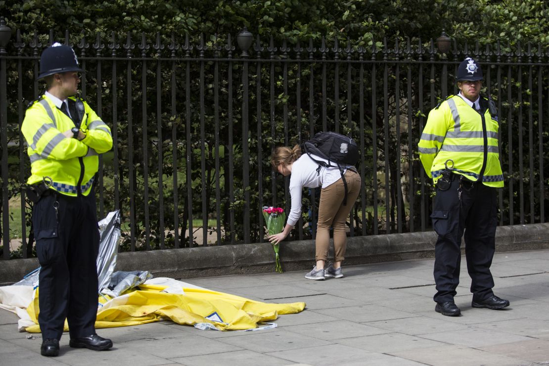 A woman lays flowers at the scene of the knife attack in London's Russell Square  on Thursday.