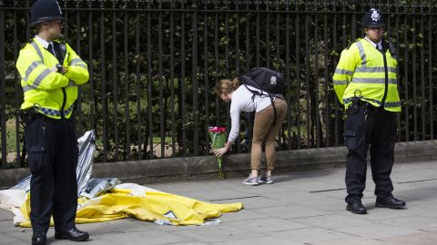 A woman lays flowers at the scene of the knife attack in London's Russell Square on Thursday.