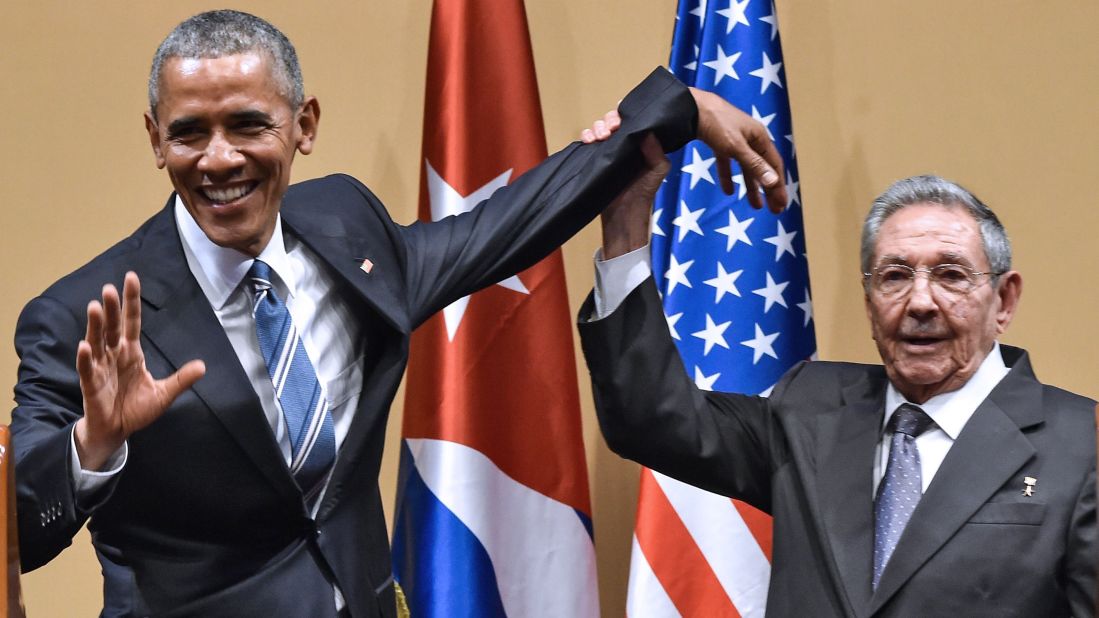 Cuban President Raul Castro tries to lift up Obama's arm at the end of a joint news conference in Havana, Cuba, in March 2016. Castro hailed Obama's opposition to a long-standing economic "blockade," but said it would need to end before ties between the two countries are fully normalized.